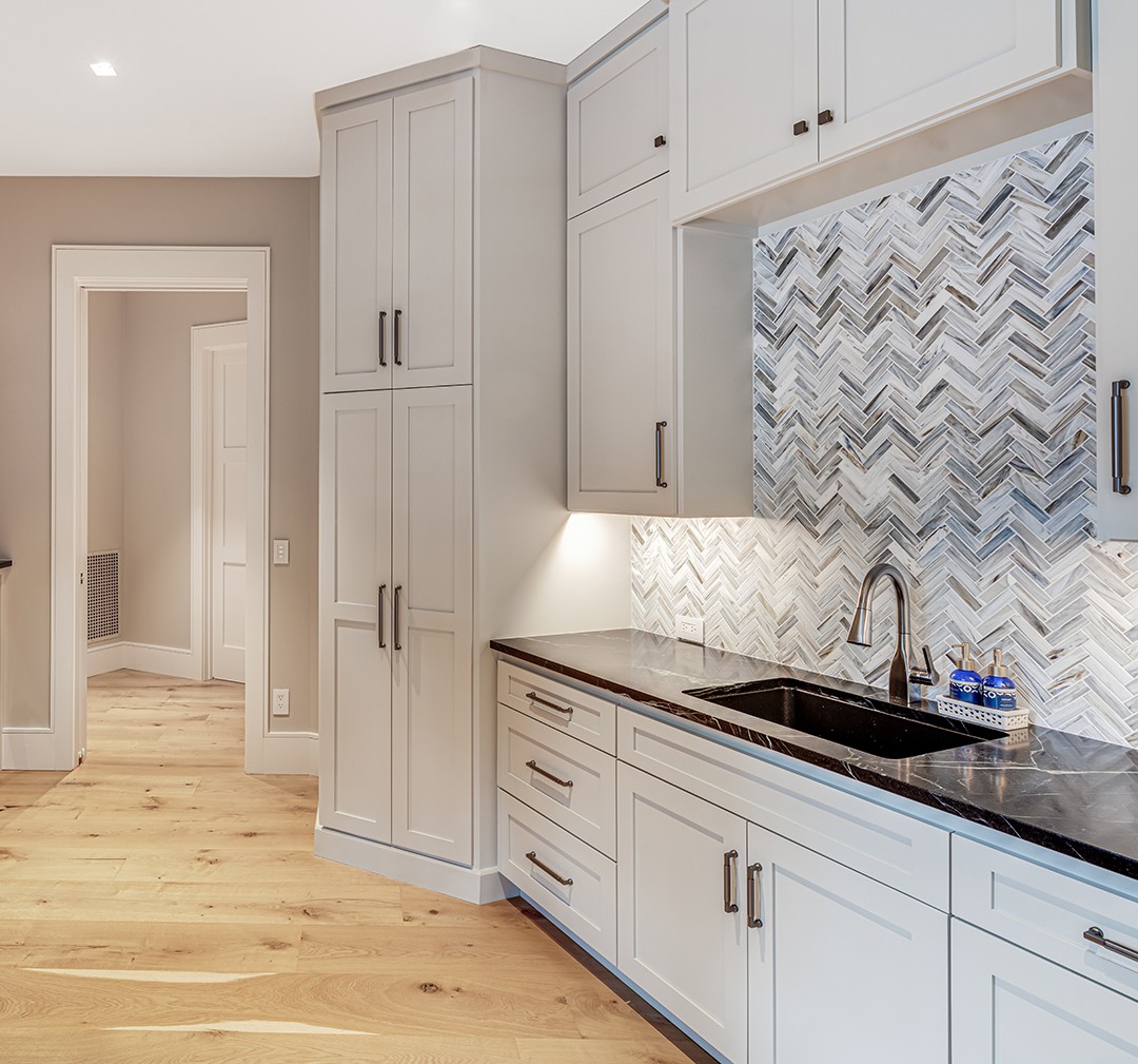 Utility room with herringbone tile flooring and custom cabinetry — Mac & Morgan Interiors design selections, Seneca SC